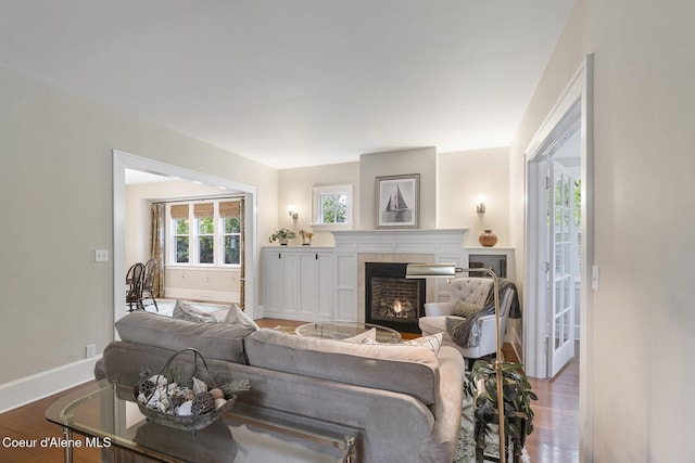 306 S Huron Ave, Sandpoint, ID 83864 - living room featuring baseboards, a tile fireplace, and wood finished floors