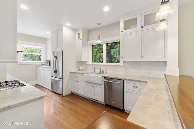306 S Huron Ave, Sandpoint, ID 83864 - kitchen with white cabinets, light wood-style floors, stainless steel appliances, and a sink