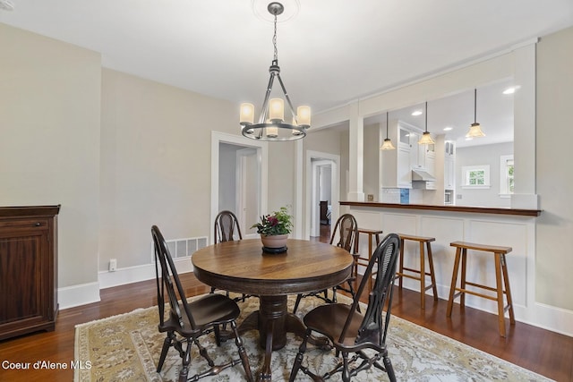 306 S Huron Ave, Sandpoint, ID 83864 - dining area with a chandelier, baseboards, and dark wood-type flooring