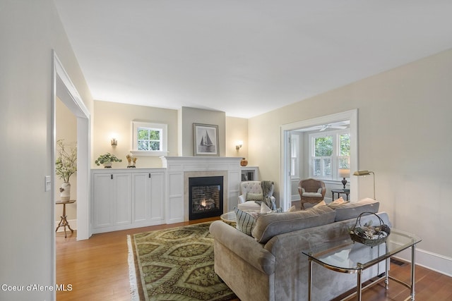 306 S Huron Ave, Sandpoint, ID 83864 - living area with a lit fireplace, wood finished floors, and baseboards