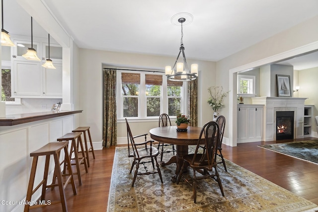 306 S Huron Ave, Sandpoint, ID 83864 - dining area featuring baseboards, a chandelier, dark wood-style flooring, and a fireplace