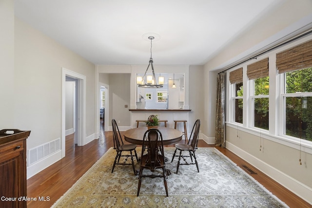 306 S Huron Ave, Sandpoint, ID 83864 - dining room featuring a chandelier, a wealth of natural light, visible vents, and wood finished floors