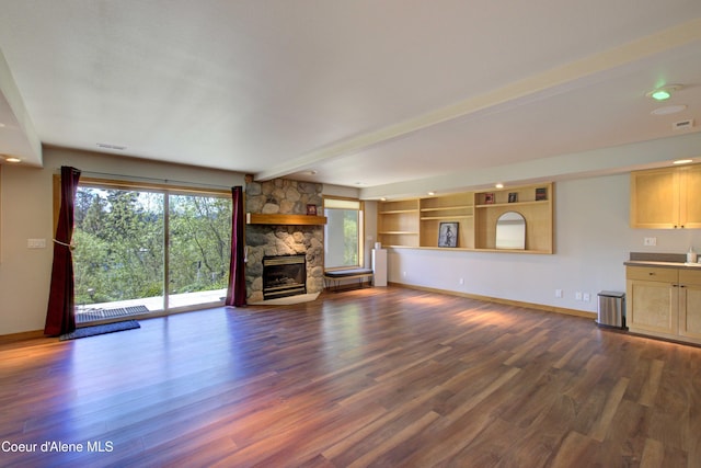 17718 E Cape Horn Rd, Bayview, ID 83803 - unfurnished living room with dark wood finished floors, baseboards, a fireplace, and beamed ceiling