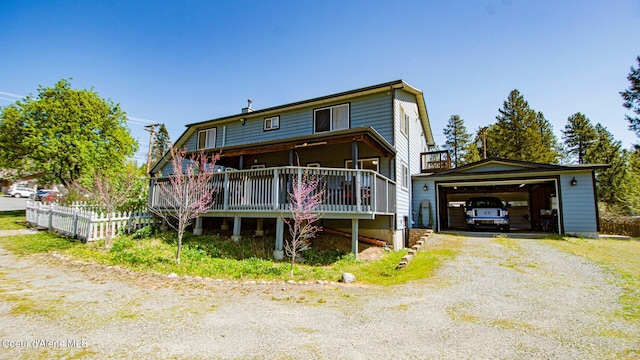 6616 Comanche St, Bonners Ferry, ID 83805 - rear view of house featuring fence, a garage, and an outdoor structure