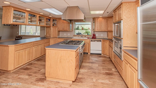 6616 Comanche St, Bonners Ferry, ID 83805 - kitchen with a center island, glass insert cabinets, a sink, light wood-style floors, and appliances with stainless steel finishes
