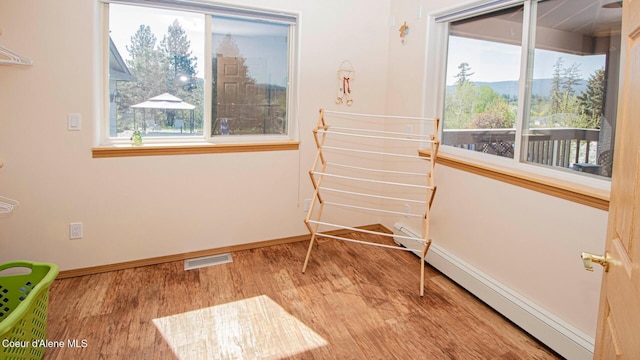 6616 Comanche St, Bonners Ferry, ID 83805 - unfurnished room featuring baseboards, visible vents, wood finished floors, and baseboard heating