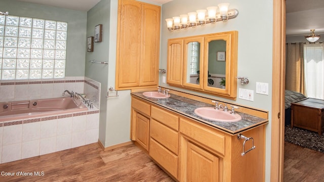 6616 Comanche St, Bonners Ferry, ID 83805 - ensuite bathroom featuring plenty of natural light, a sink, and wood finished floors