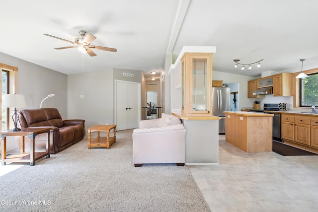 living room featuring vaulted ceiling, visible vents, and ceiling fan