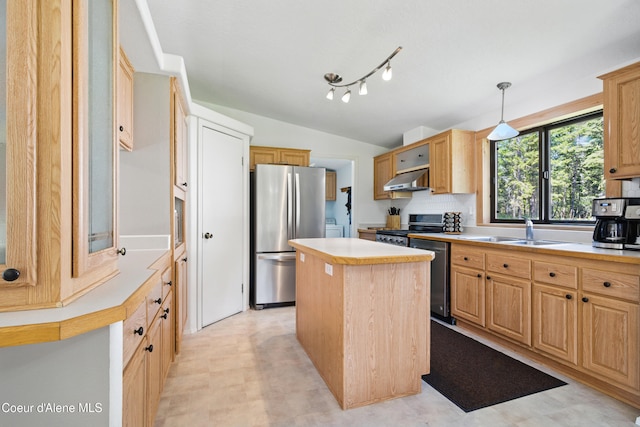 kitchen with exhaust hood, stainless steel appliances, a sink, vaulted ceiling, and light countertops