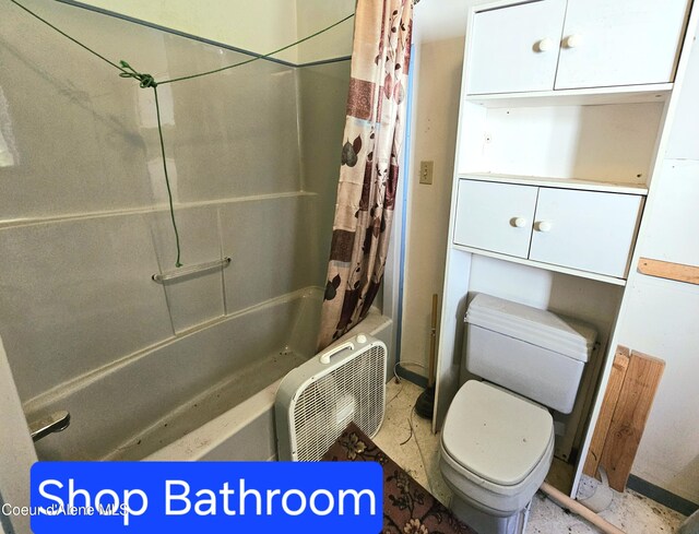 bathroom with toilet and shower / bath combo with shower curtain