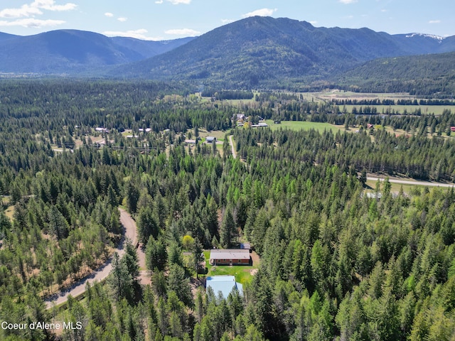 aerial view with a wooded view and a mountain view