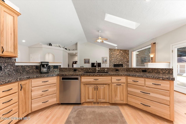 12795 N Yearling Cir, Hayden, ID 83835 - kitchen with light brown cabinets, dishwasher, ceiling fan, a sink, and light wood-style floors