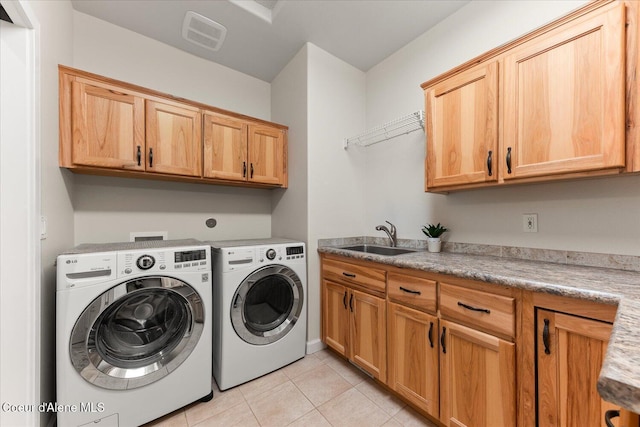 12795 N Yearling Cir, Hayden, ID 83835 - washroom featuring light tile patterned floors, visible vents, a sink, washing machine and clothes dryer, and cabinet space