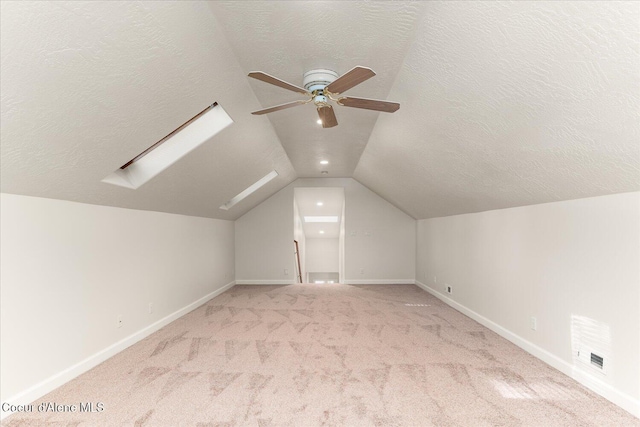 12795 N Yearling Cir, Hayden, ID 83835 - bonus room featuring light colored carpet, a textured ceiling, lofted ceiling with skylight, and ceiling fan