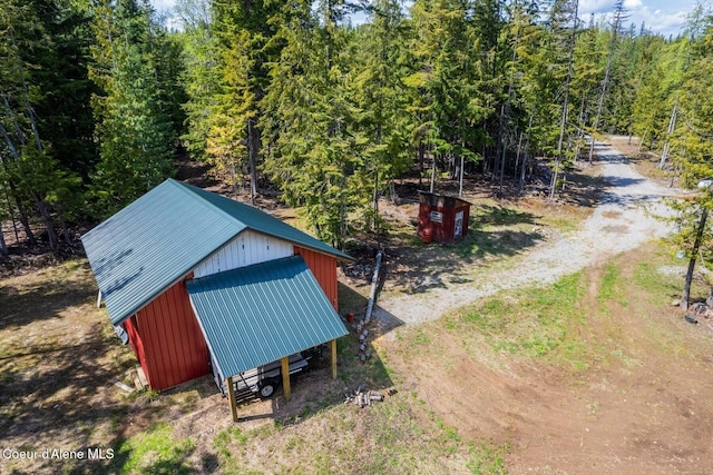 760 Fox Glen Rd, Sandpoint, ID 83864 - view of outbuilding with a wooded view, an outbuilding, and driveway