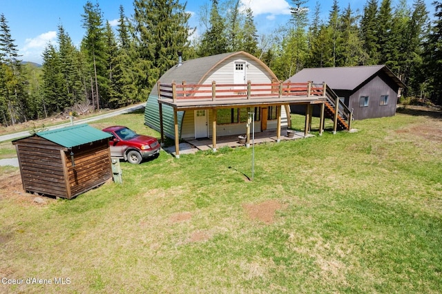 760 Fox Glen Rd, Sandpoint, ID 83864 - rear view of property with stairway, a wooden deck, and a lawn