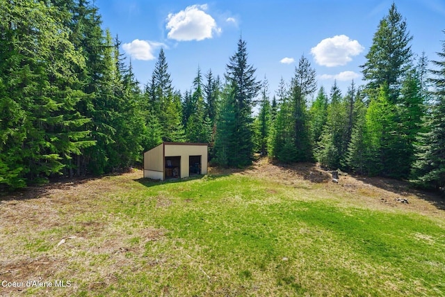 760 Fox Glen Rd, Sandpoint, ID 83864 - view of yard featuring an outbuilding and a view of trees