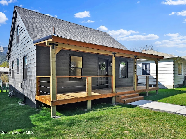 513 Mission Ave, Kellogg, ID 83837 - view of front of property with covered porch, roof with shingles, and a front yard