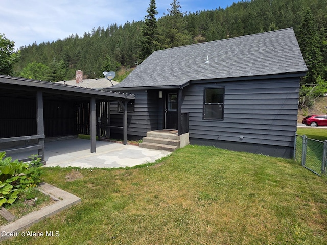 513 Mission Ave, Kellogg, ID 83837 - view of front of house with a wooded view and a shingled roof