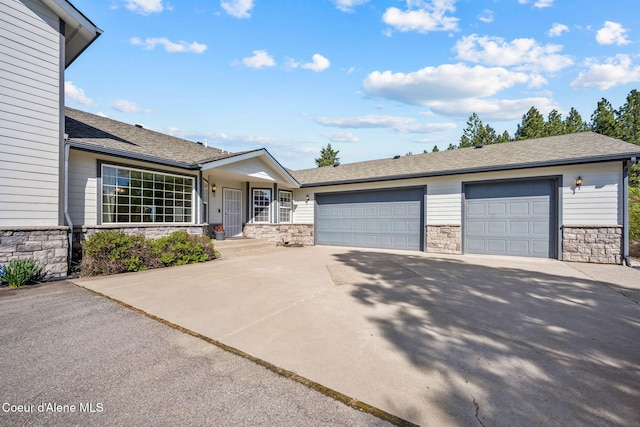 ranch-style house featuring stone siding, driveway, a garage, and a shingled roof