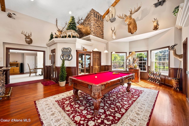 playroom featuring high vaulted ceiling, a wainscoted wall, billiards, wood finished floors, and wooden walls