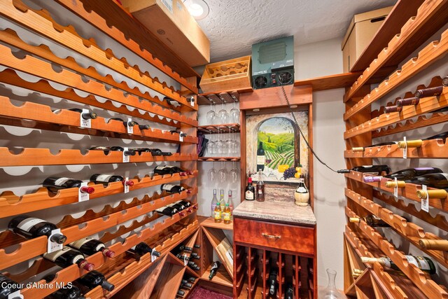 wine area featuring a textured ceiling