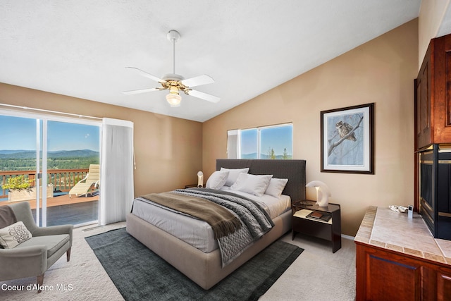 bedroom with vaulted ceiling, access to outside, light carpet, and ceiling fan