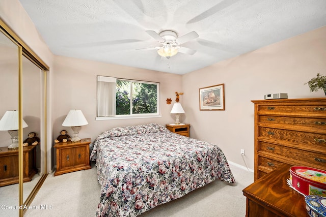 bedroom with a closet, carpet floors, a ceiling fan, and baseboards