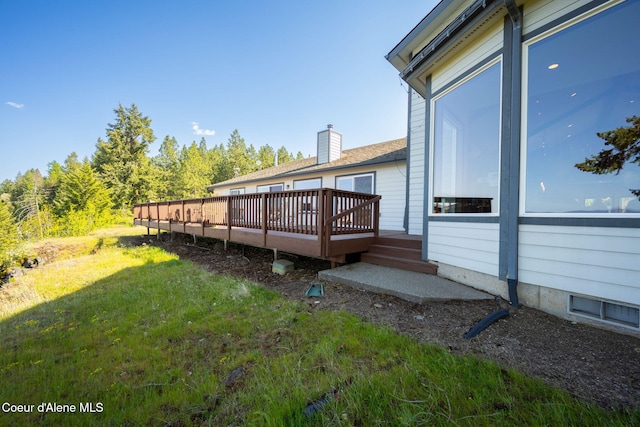 view of grassy yard featuring a deck