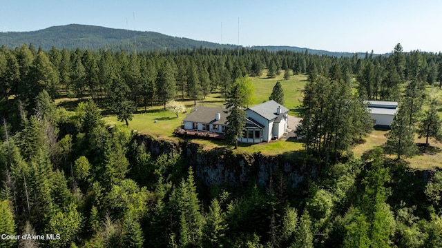 view of subject property featuring a forest and mountains