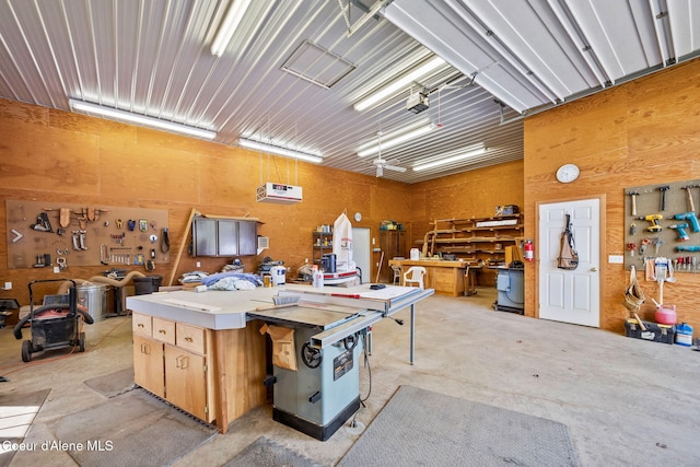 garage with a workshop area and a garage door opener