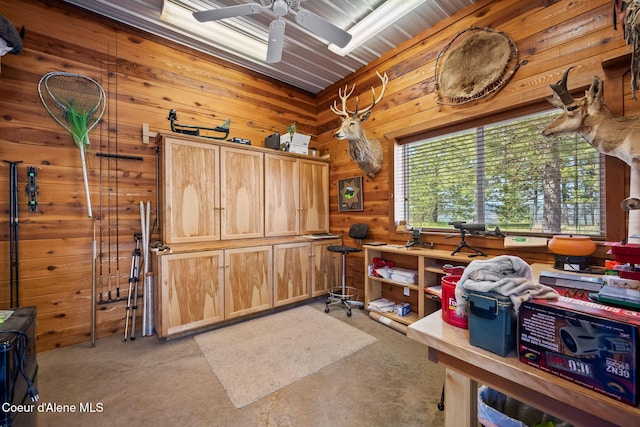 office featuring light colored carpet, wooden walls, and ceiling fan