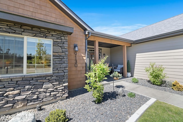 view of exterior entry with stone siding