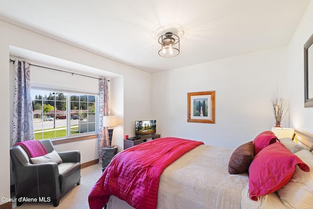 bedroom featuring carpet flooring and baseboards