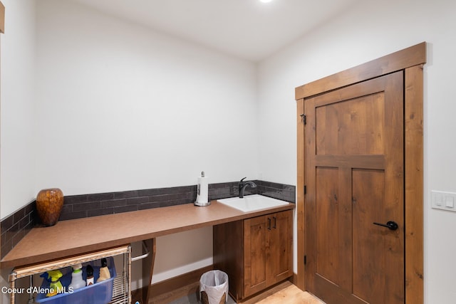 washroom with a sink and light wood-style floors