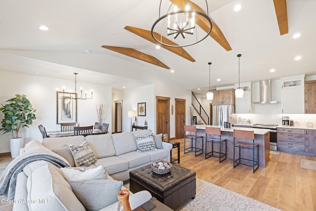 living area featuring a chandelier, light wood-type flooring, lofted ceiling, recessed lighting, and stairway