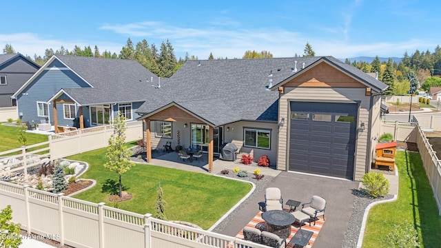 view of front of house with an attached garage, driveway, and roof with shingles