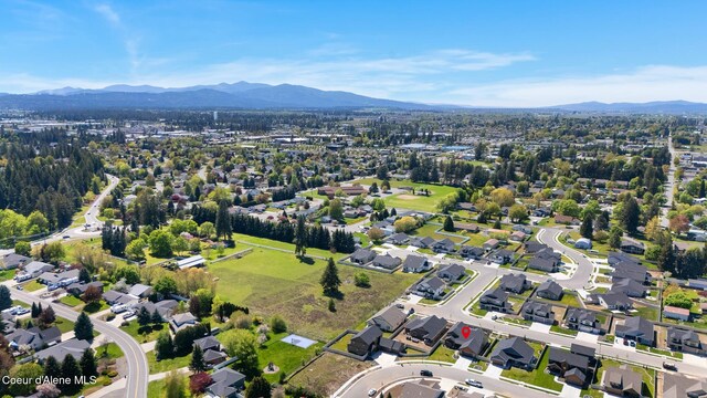 aerial overview of property's location with a mountain backdrop and nearby suburban area