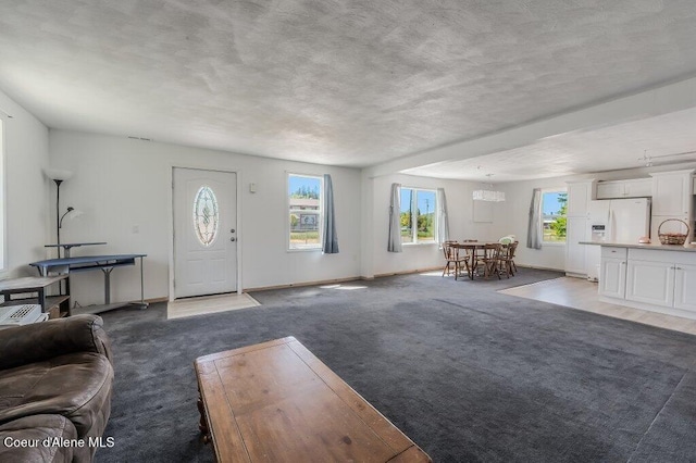 9727 W E St, Worley, ID 83876 - living area featuring carpet and a chandelier