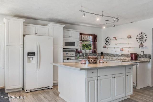 9727 W E St, Worley, ID 83876 - kitchen featuring white appliances, light wood-style flooring, and white cabinetry
