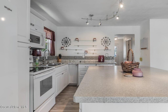 9727 W E St, Worley, ID 83876 - kitchen with white appliances, tasteful backsplash, white cabinets, light countertops, and wood finished floors