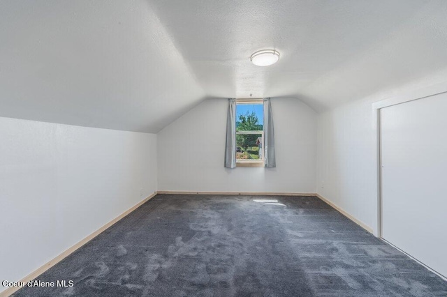 9727 W E St, Worley, ID 83876 - bonus room featuring lofted ceiling, carpet floors, and a textured ceiling