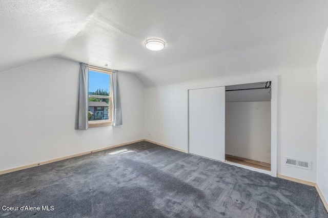 9727 W E St, Worley, ID 83876 - additional living space featuring vaulted ceiling, a textured ceiling, and carpet
