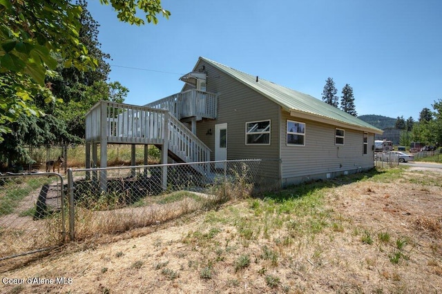 9727 W E St, Worley, ID 83876 - view of property exterior featuring a wooden deck, stairway, and a metal roof