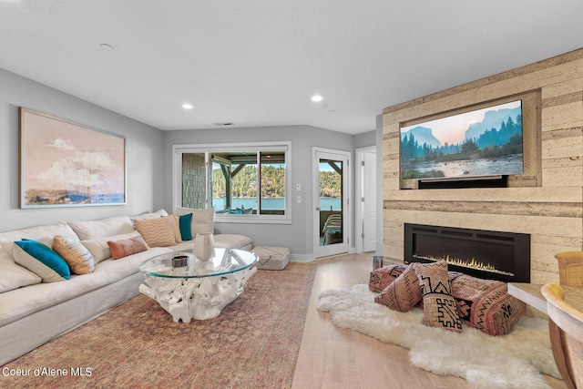 4797 S Arrow Point Dr # 102, Harrison, ID 83833 - living room with baseboards, a fireplace, recessed lighting, and wood finished floors