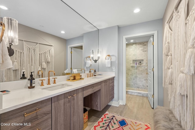 4797 S Arrow Point Dr # 102, Harrison, ID 83833 - bathroom featuring a shower stall, double vanity, a sink, and wood finished floors