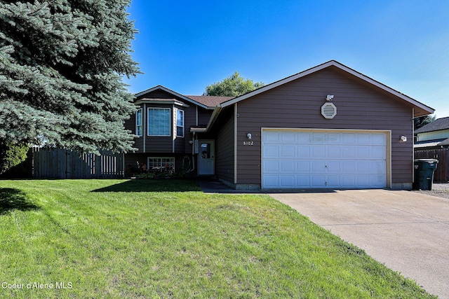 8102 W Arizona St, Rathdrum, ID 83858 - tri-level home with an attached garage and concrete driveway