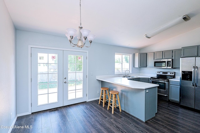 8102 W Arizona St, Rathdrum, ID 83858 - kitchen featuring appliances with stainless steel finishes, a peninsula, gray cabinets, french doors, and dark wood-style flooring