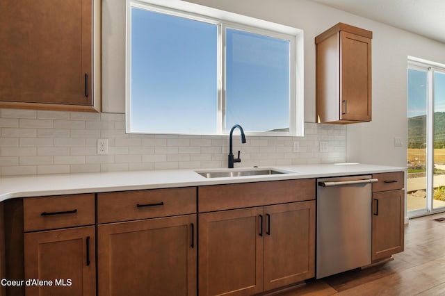 6760 Portrush Dr, Rathdrum, ID 83858 - kitchen with backsplash, light countertops, stainless steel dishwasher, and a sink