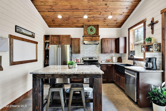 kitchen featuring wooden ceiling, vaulted ceiling, stainless steel appliances, and a sink
